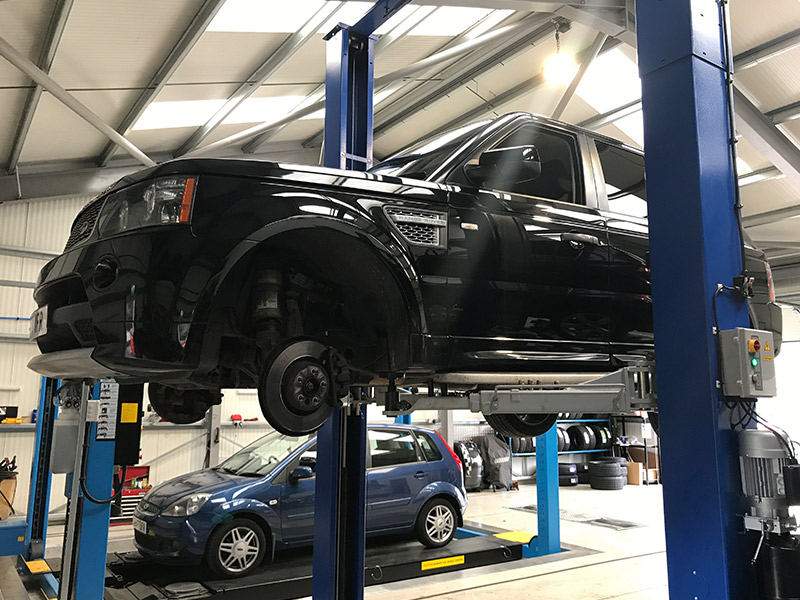 Range Rover on workshop ramp having a service